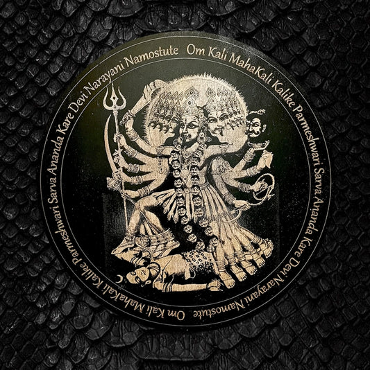 Circular emblem with a deity illustration and text on a textured black background
