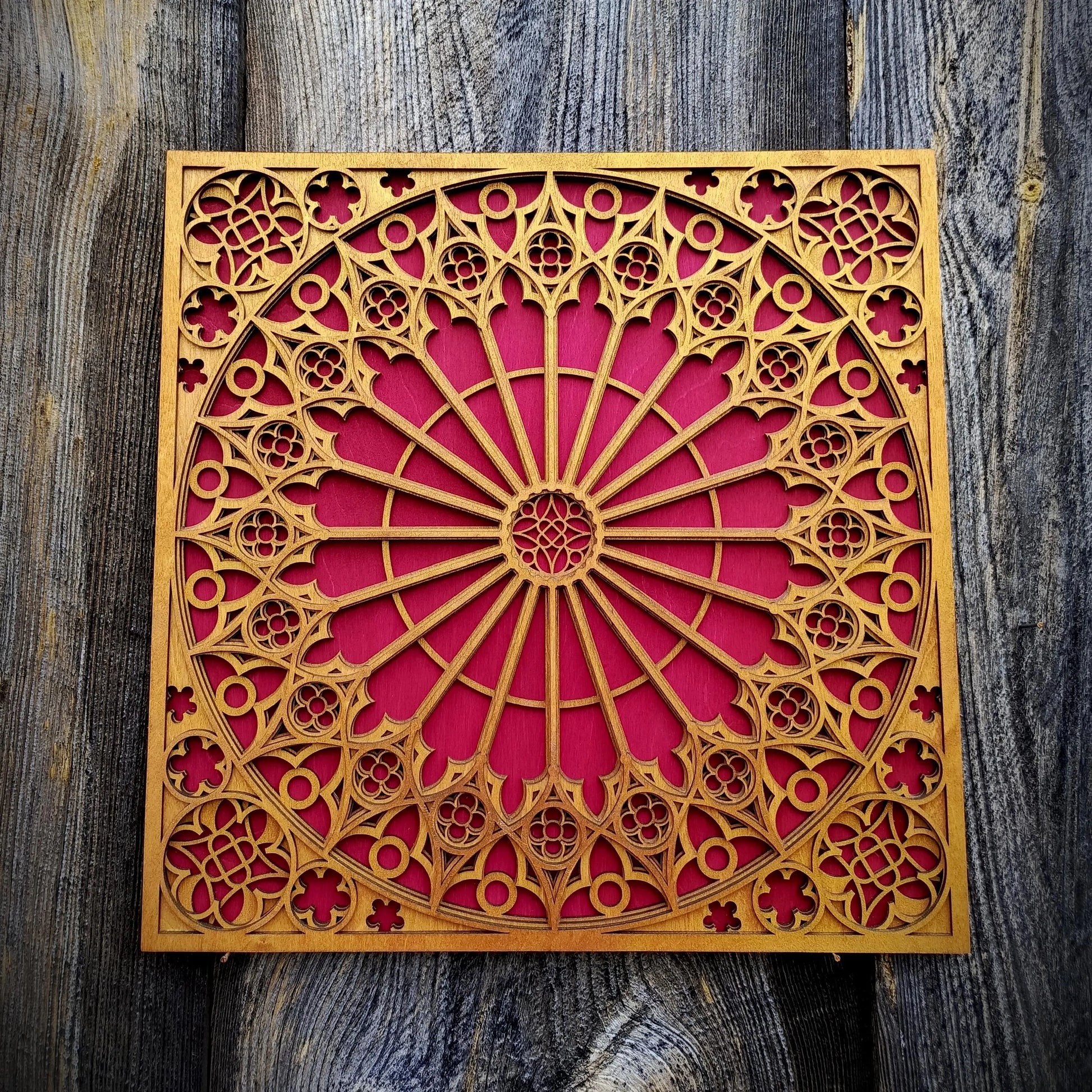 Decorative wooden panel with intricate cut-out patterns on a wooden surface